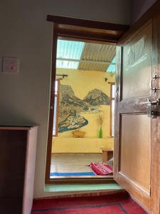 a door to a room with a painting on the wall at SpitiDiaries Homestay in Kaza