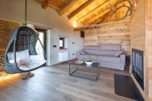 a living room with a couch and a swing at L’Ozio Creativo in Castelnuovo Nigra