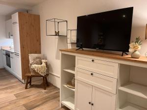 a living room with a tv on top of a desk at Ferienwohnung Agena in Schliersee