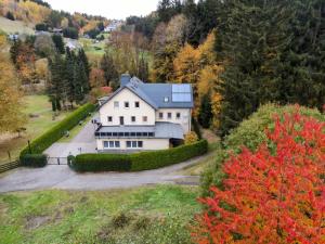 an aerial view of a house in the mountains at Haus Wiesenbaude in Bärenstein