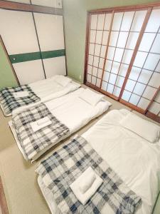 Postel nebo postele na pokoji v ubytování KIBA HOUSE
