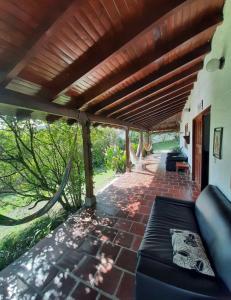 un patio con un sofá bajo una pérgola en Finca La Esperanza, en Calima