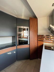 a kitchen with a stove and a microwave at He-Ra Apartments City Centre in Skopje