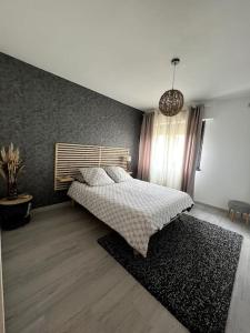 1 dormitorio con 1 cama con alfombra negra en Joli appartement à Fegersheim, en Fegersheim