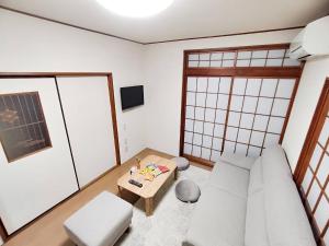 un soggiorno con divano e tavolo di KIBA HOUSE a Tokyo