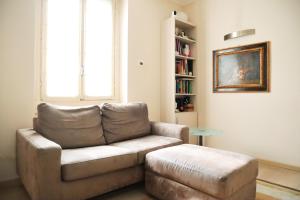 a living room with a couch and a table at Repubblica Elegant Milan House in Milan