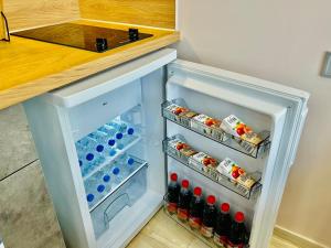 an open refrigerator with food and drinks in it at PORT TWINS SUITES No1 in Piraeus