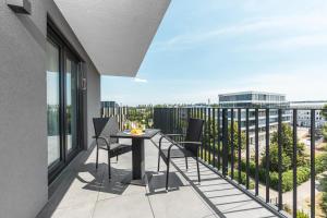 a balcony with a table and chairs on it at Livingroom Bad Homburg Boardinghouse in Bad Homburg vor der Höhe