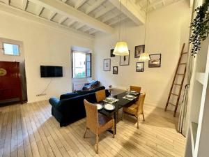 a living room with a couch and a table at Near Ponte Vecchio: central luxury flat in Florence