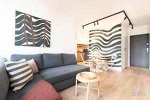 a living room with a couch and a table at Baltic Breeze Apartment 3city Gdańsk by Noclegi Renters in Gdańsk