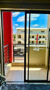 a view of a balcony from an open glass door at Chic Urban Loft in Pretoria in Pretoria