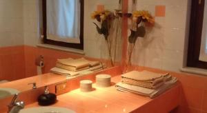 a bathroom with a sink and a mirror and towels at B&B Country House Crema in Crema +57 photos