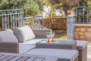 two wine glasses on a tray on an outdoor table at Elysian Rose Residence in Rethymno +31 photos