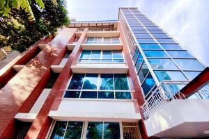 a tall building with many windows on it at Crown Palace Residence in Dhaka