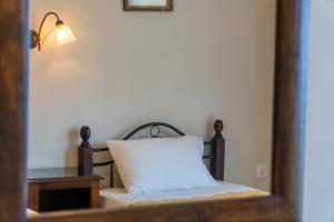 a pillow sitting on a bed in a room at Mazis Studio B2 in Agios Gordios