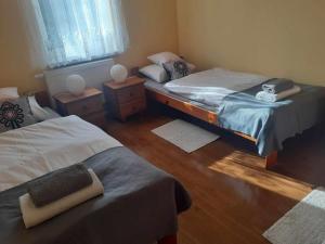 a bedroom with two twin beds and a window at Lochówka - zaciszny domek w górach in Krynica Zdrój +25 photos