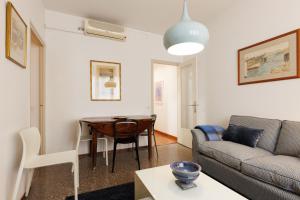 a living room with a table and a couch at Lodging Apartments Gracia 2 in Barcelona