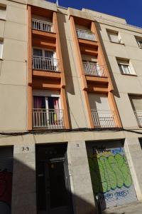 a building with balconies and a door in front of it at Lodging Apartments Gracia 2 in Barcelona