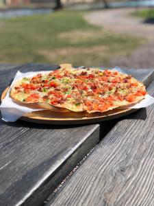 a pizza sitting on a plate on a table at Mallboden Café & Vandrarhem in Motala