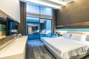 a bedroom with a bed and a large window at Gözegir Hotel in Bodrum City