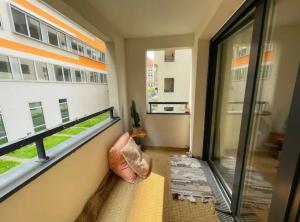 a room with a balcony with a large window at La Belle Échappée à Montreuil in Montreuil