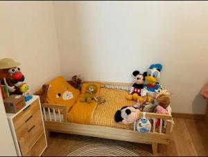 a bedroom with a bed with stuffed animals on it at La Belle Échappée à Montreuil in Montreuil