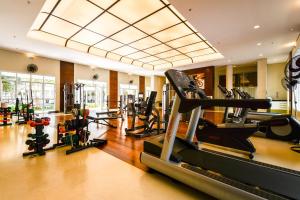 a gym with treadmills and ellipticals in a room at Çiragan Apartments by BnbHost in Sao Paulo