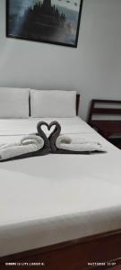 a swan decoration on a bed in a bedroom at duck inn manila in Manila