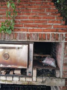 a brick wall with a brick oven underneath it at Casa Redonda in Monte Grande