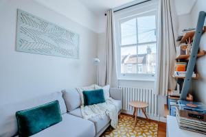 a living room with a couch and a window at Cliffden Apartment - One bed apartment in London