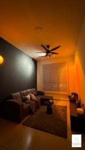 a living room with a couch and a ceiling fan at Hot & Wild Couple Room@Cheras KL in Cheras