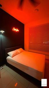 a bedroom with a bed with red lights on it at Hot & Wild Couple Room@Cheras KL in Cheras