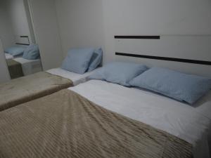 a bedroom with two beds and a mirror at Ocean Atlantic Praia de Iracema in Fortaleza