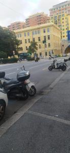 a row of scooters parked on the side of a street at Appartamento in centro in Genova