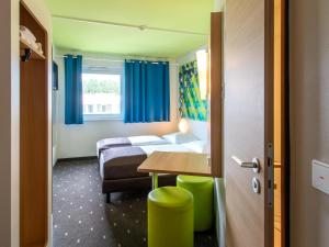 Postel nebo postele na pokoji v ubytování B&B Hotel Erlangen-Süd