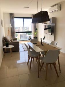 cocina y sala de estar con mesa y sillas en Agustín I Apart en Paraná