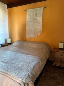 a bedroom with a bed with a curtain on the wall at El Mirador, Apartamento in Punta Del Diablo