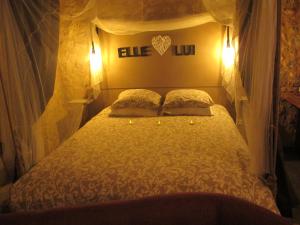 a bedroom with a bed with two pillows on it at L'écrin de Najatte in Bourg-sur-Gironde