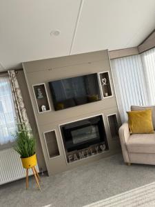 a living room with a tv and a couch at Coastguard 45 in Whitstable