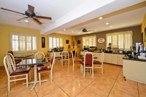 a kitchen and dining room with tables and chairs at Super 8 by Wyndham El Paso Airport in El Paso