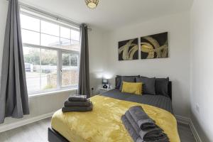 a bedroom with a bed and a large window at Comfy Stay 1 Bedroom Apartment in Rugby