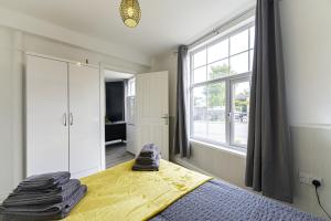 a bedroom with a bed and a large window at Comfy Stay 1 Bedroom Apartment in Rugby