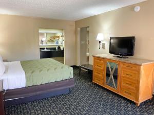 A bed or beds in a room at Studio 6 Suites North Richland Hills TX