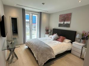 a bedroom with a bed and a glass table at Marina Club - Luxury Apartment in Ocean Village in Gibraltar +21 photos