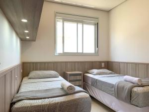 Cama o camas de una habitación en Apartamento em House Clube