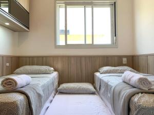 Cama o camas de una habitación en Apartamento em House Clube