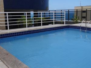 a large blue swimming pool on top of a building at Ocean Atlantic Praia de Iracema in Fortaleza