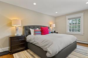 a bedroom with a large bed with two lamps at Brook Bound Inn in Wilmington