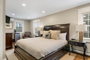 a bedroom with a large bed and a chair at Brook Bound Inn in Wilmington