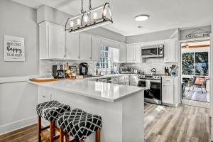 a kitchen with white cabinets and a counter top at Coastal Gem of Murrells Inlet in Myrtle Beach